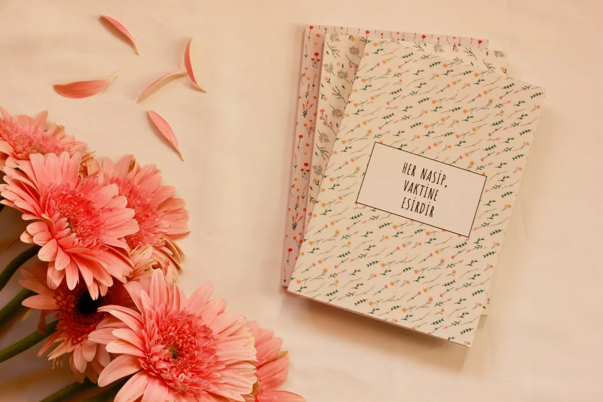 Stack of journals with decorated covers and flowers
