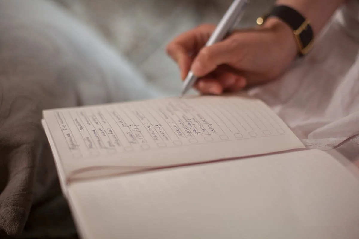 Hand writing in a bullet journal notebook