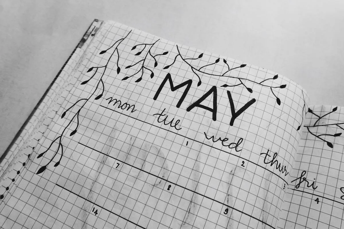 A hand-drawn bullet journal monthly log spread in a dotted notebook