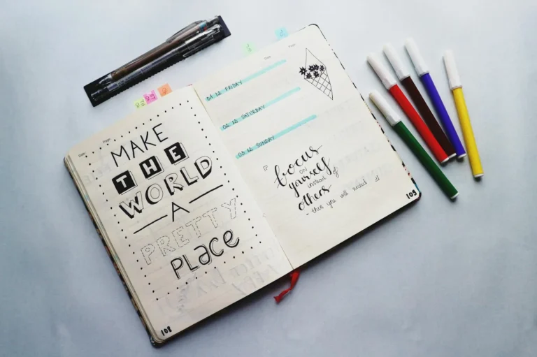 Open bullet journal with colored pencils for a mood tracker