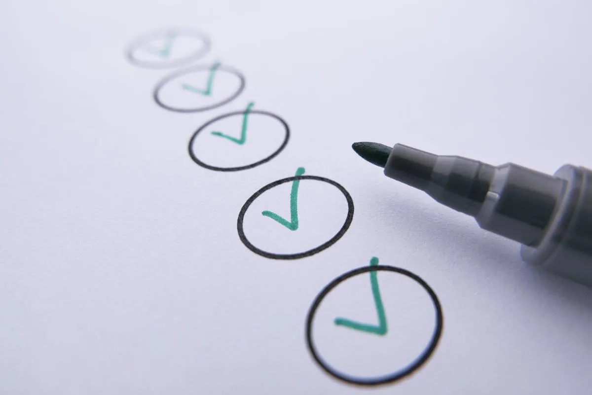 Hand-drawn checklist with green check marks beside a marker pen