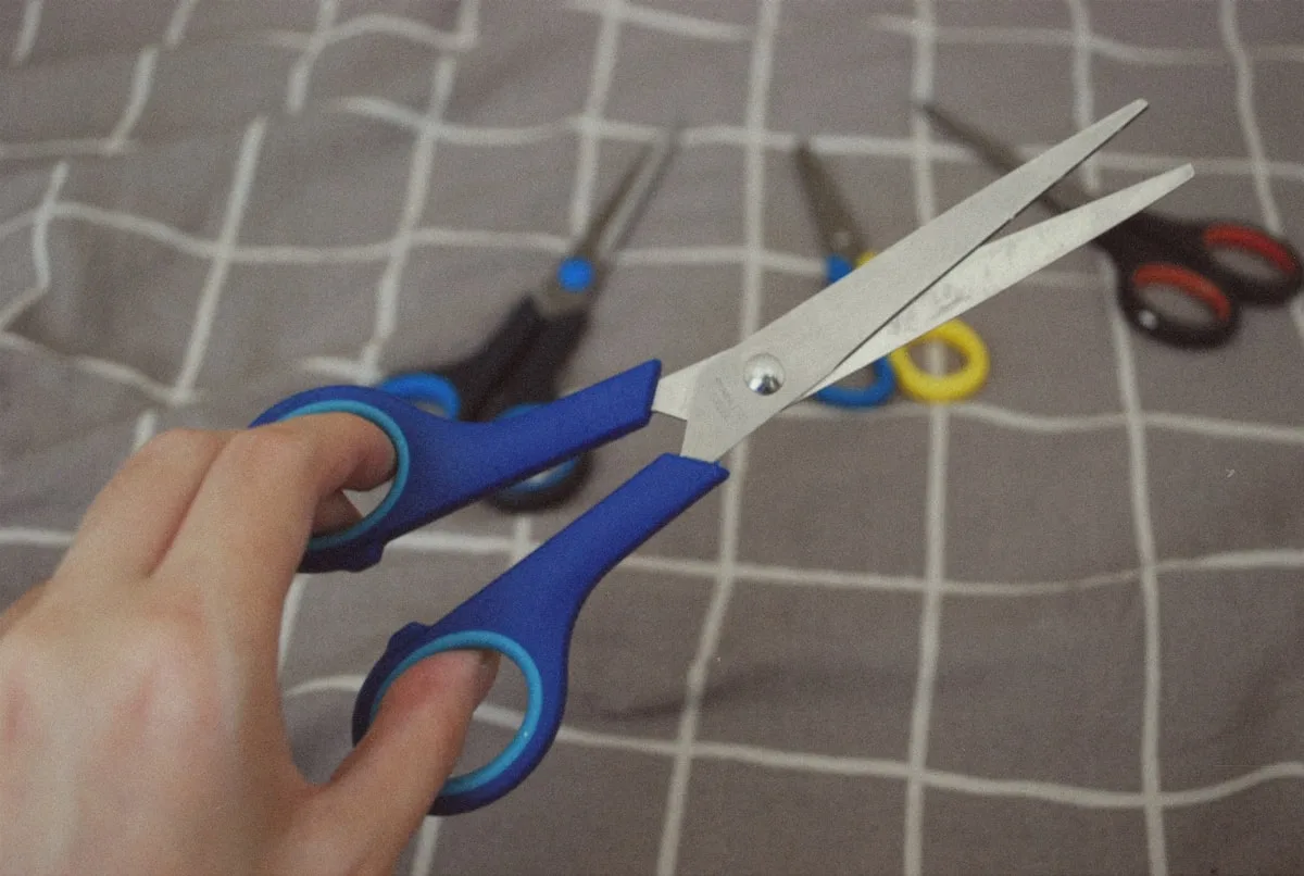 Cutting printed stickers with scissors on a cutting mat