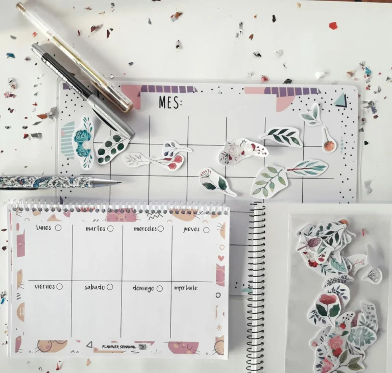Planner page decorated with journaling stickers and stationery on a desk