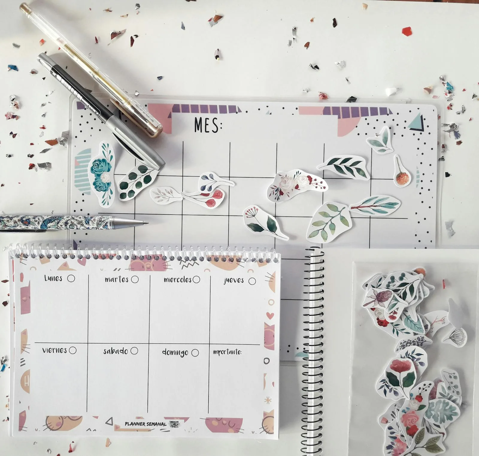 Planner page decorated with journaling stickers and stationery on a desk