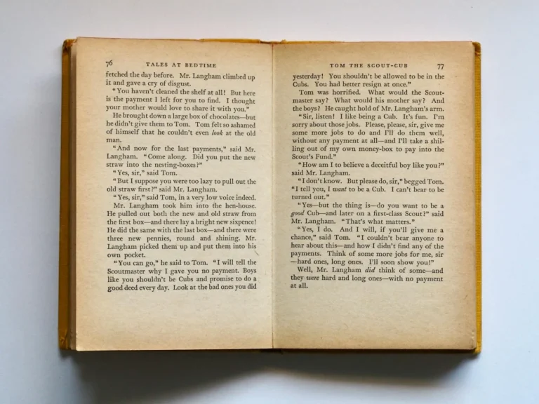 Open vintage book with yellowed printed pages ready to upcycle