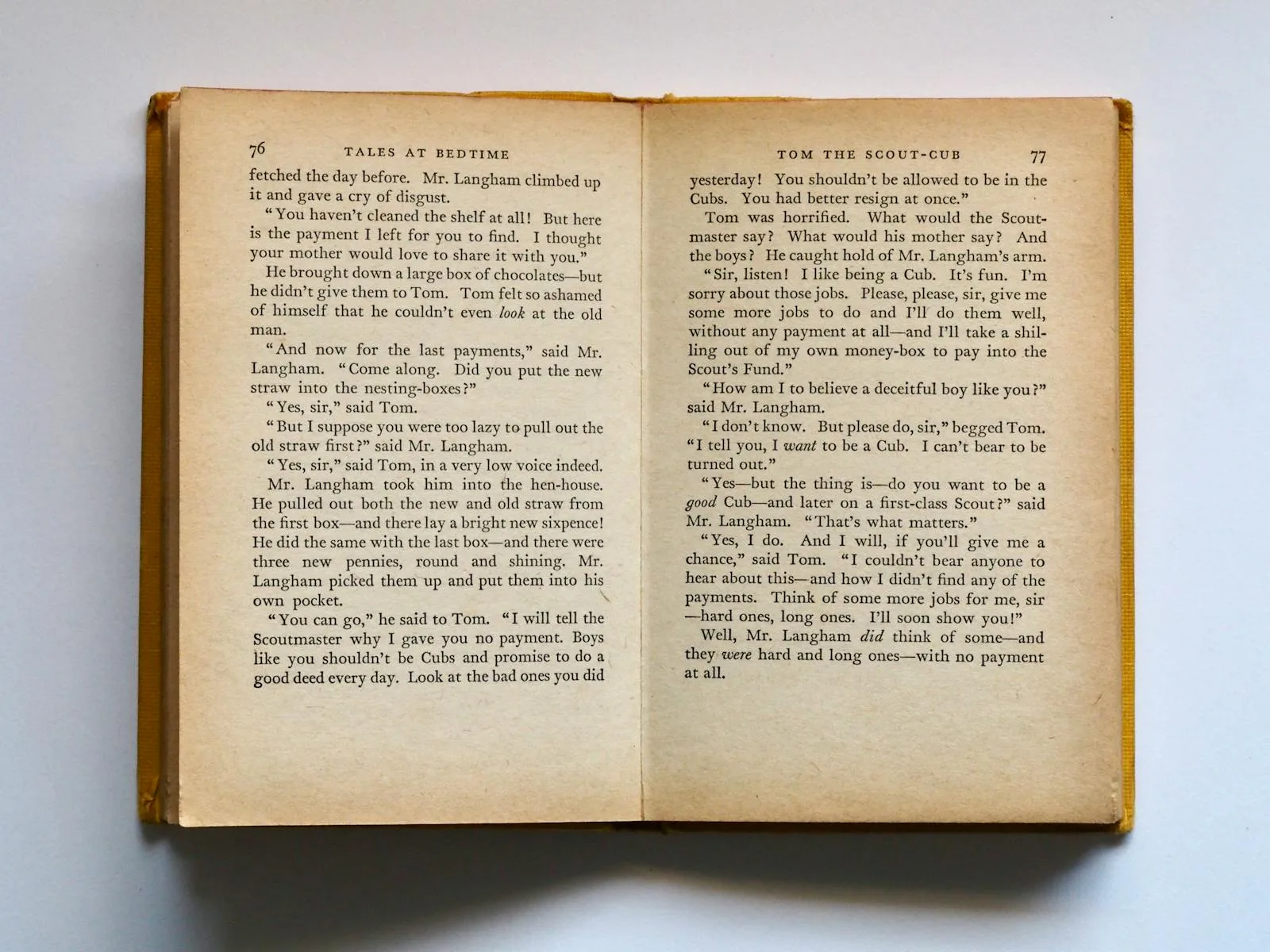 Open vintage book with yellowed printed pages ready to upcycle