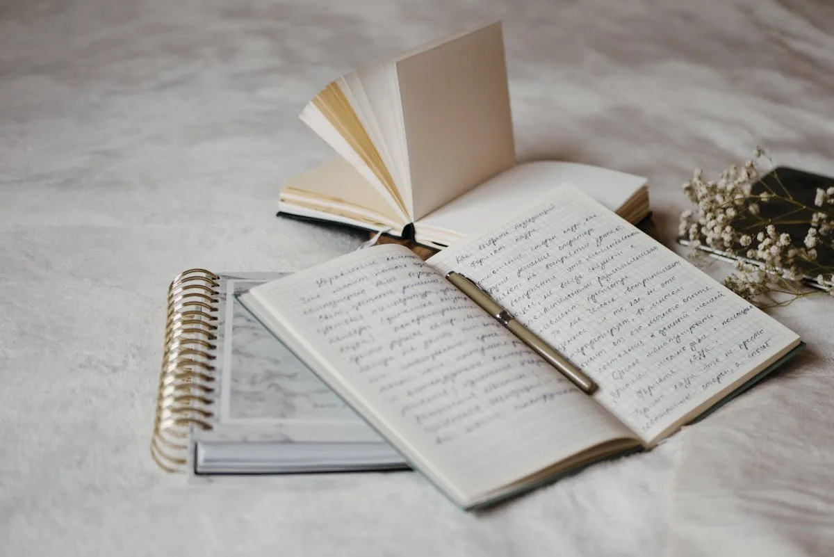 Open notebook and pen on a cozy junk journaling desk
