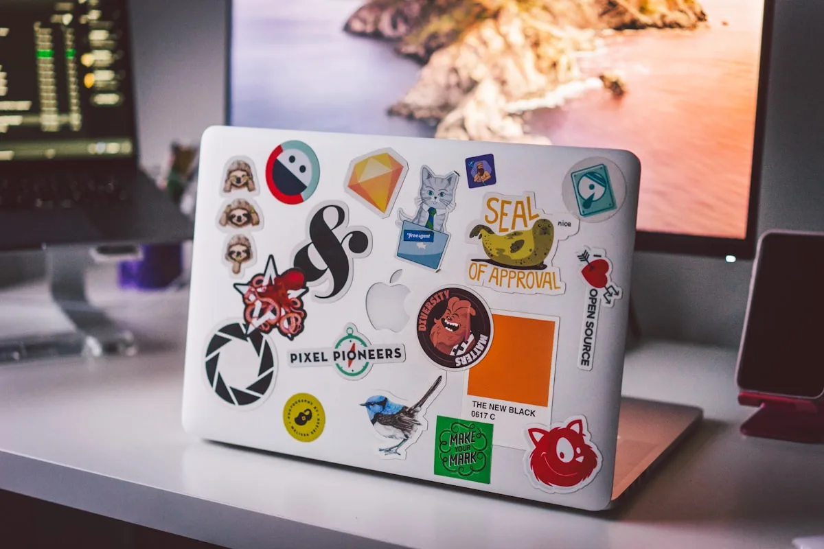 Laptop lid covered in colorful vinyl stickers