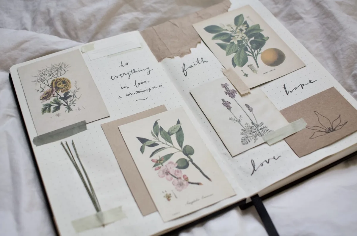 Open junk journal showing layered vintage pages and floral cards