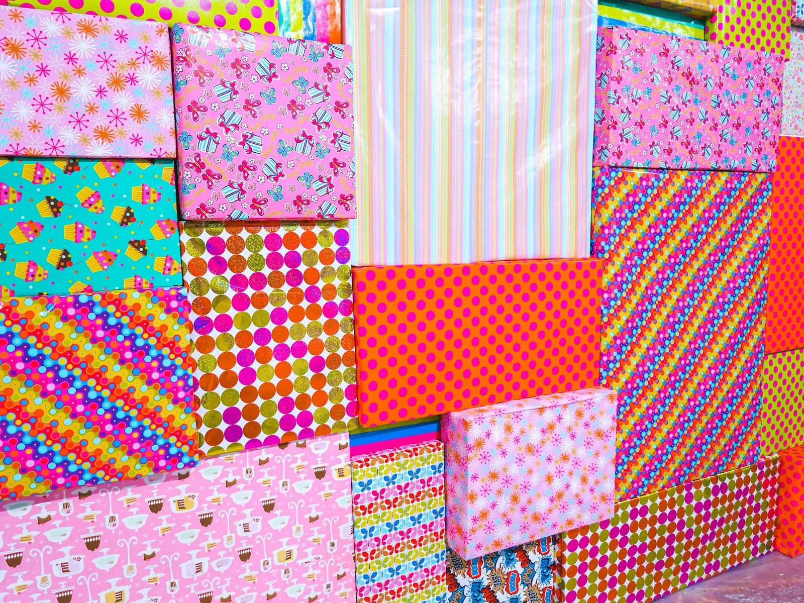 Stack of patterned scrapbook paper sheets in assorted prints and colors