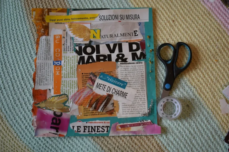 Vision board flat lay with magazine cutouts, scissors, and tape on a soft rug