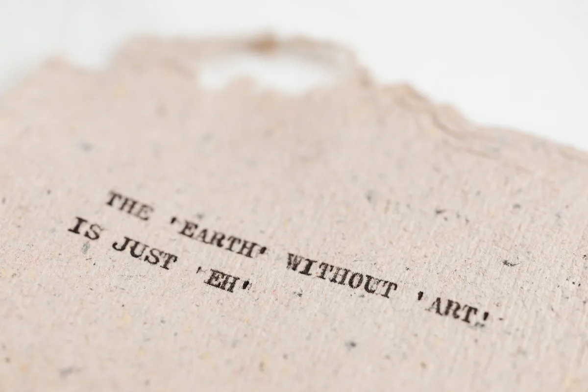 A handmade craft paper card with a printed quote, close up on the typography