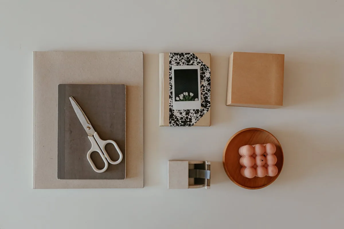 Craft supplies including stickers, scissors, and washi tape arranged on a desk