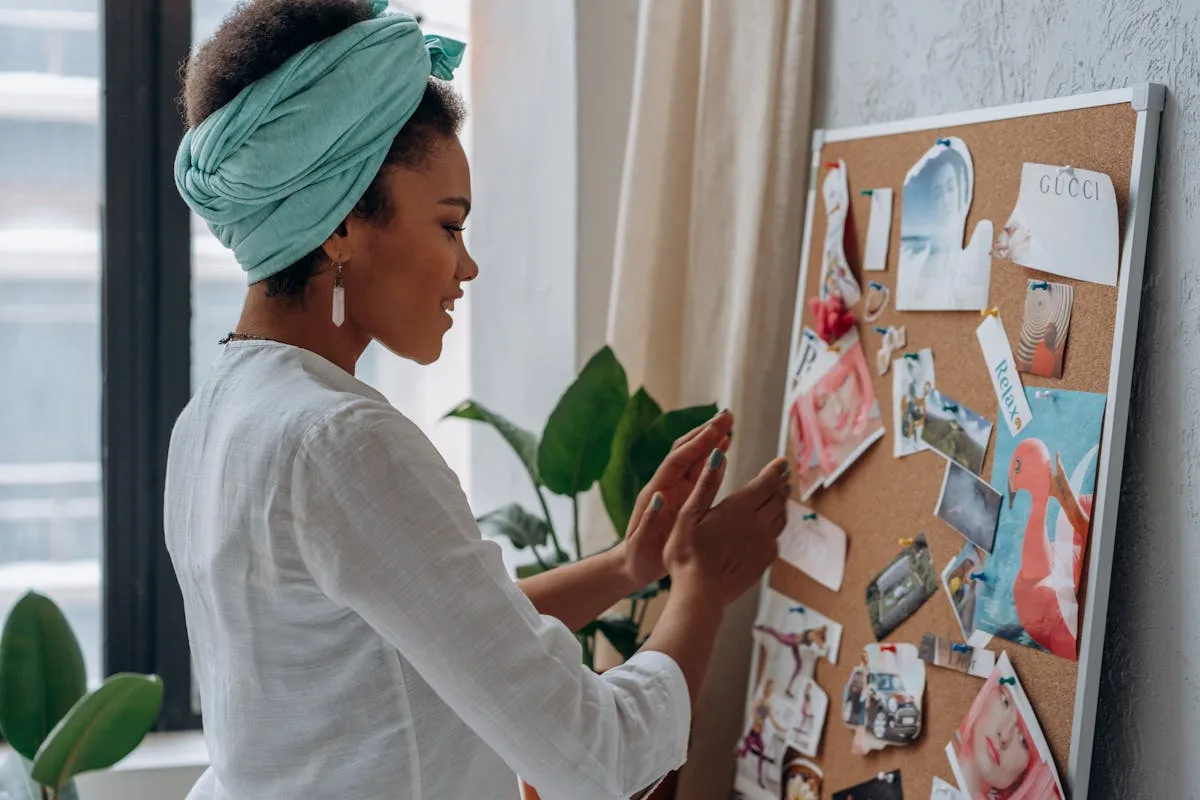 A finished collage vision board hanging on a soft neutral wall