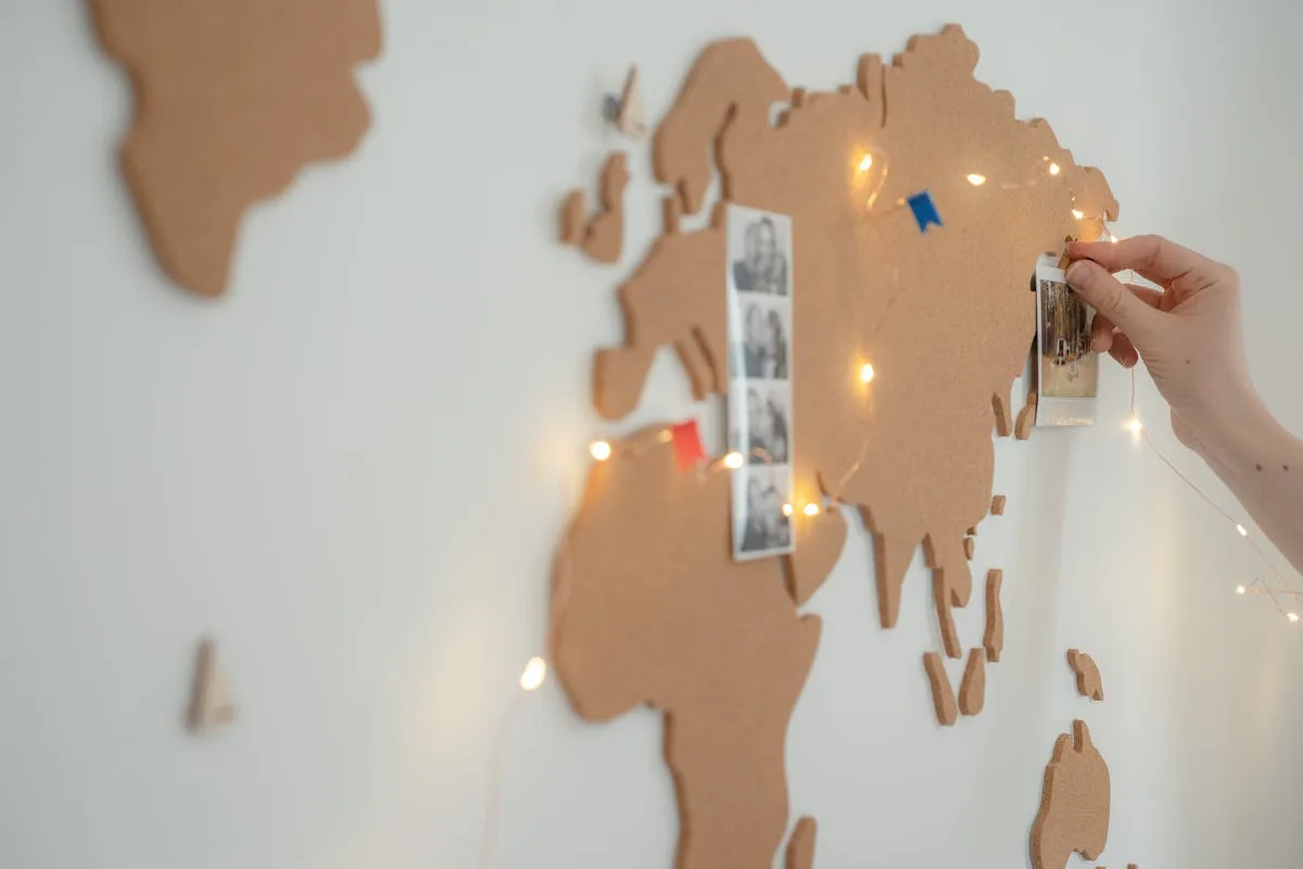 Cork board on a bedroom wall pinned with photos and quote cards