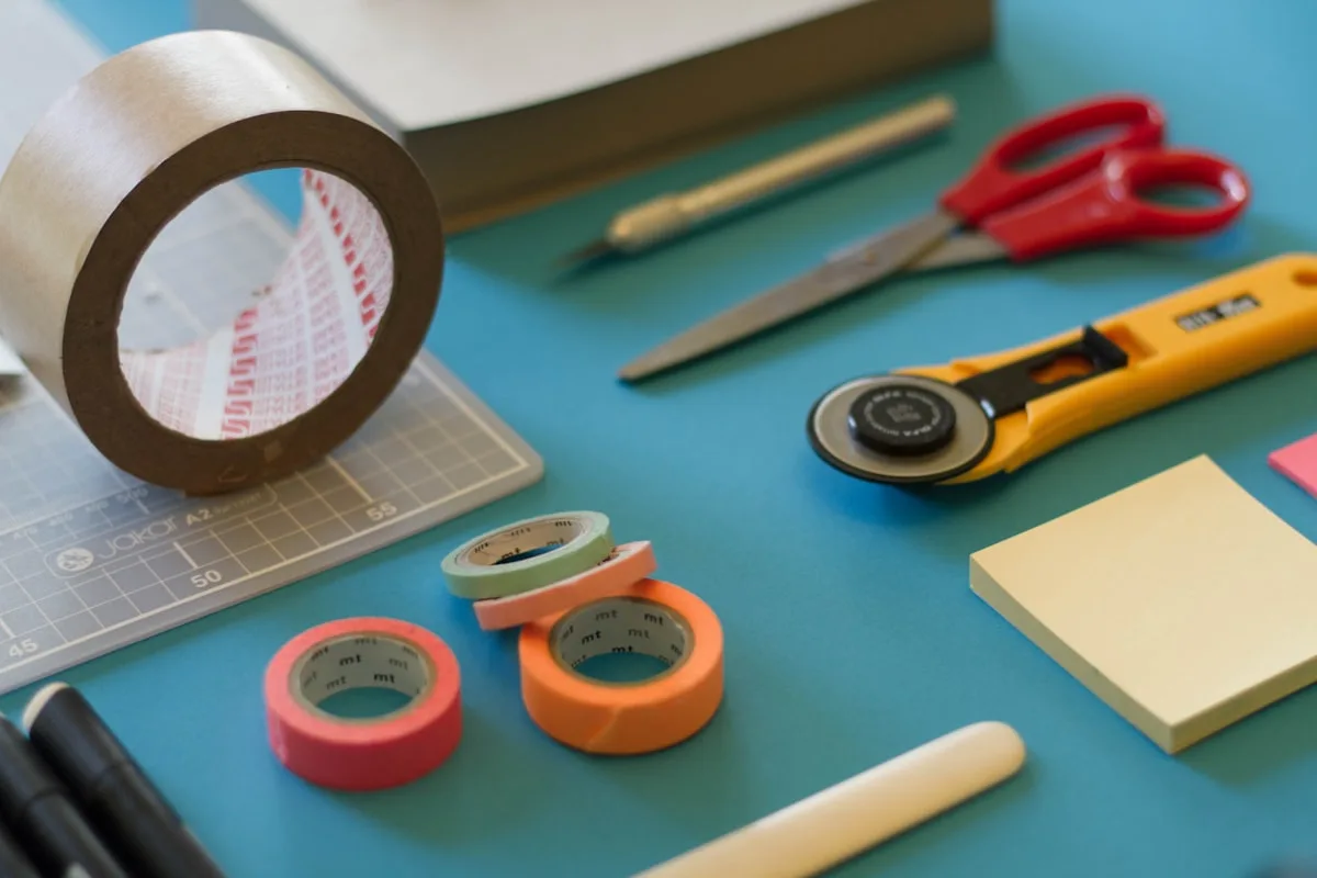 Washi tape, scissors and craft supplies laid out on a desk