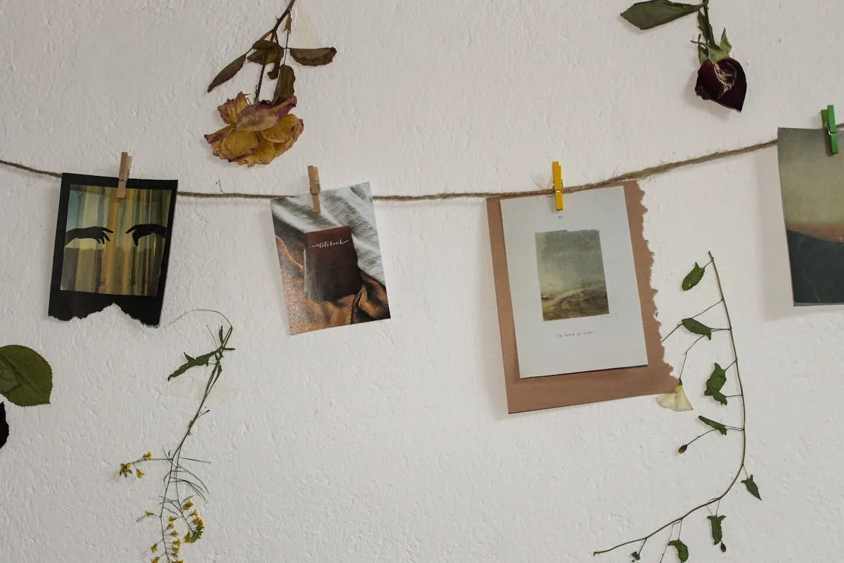 Aesthetic photo prints hung on a string with greenery