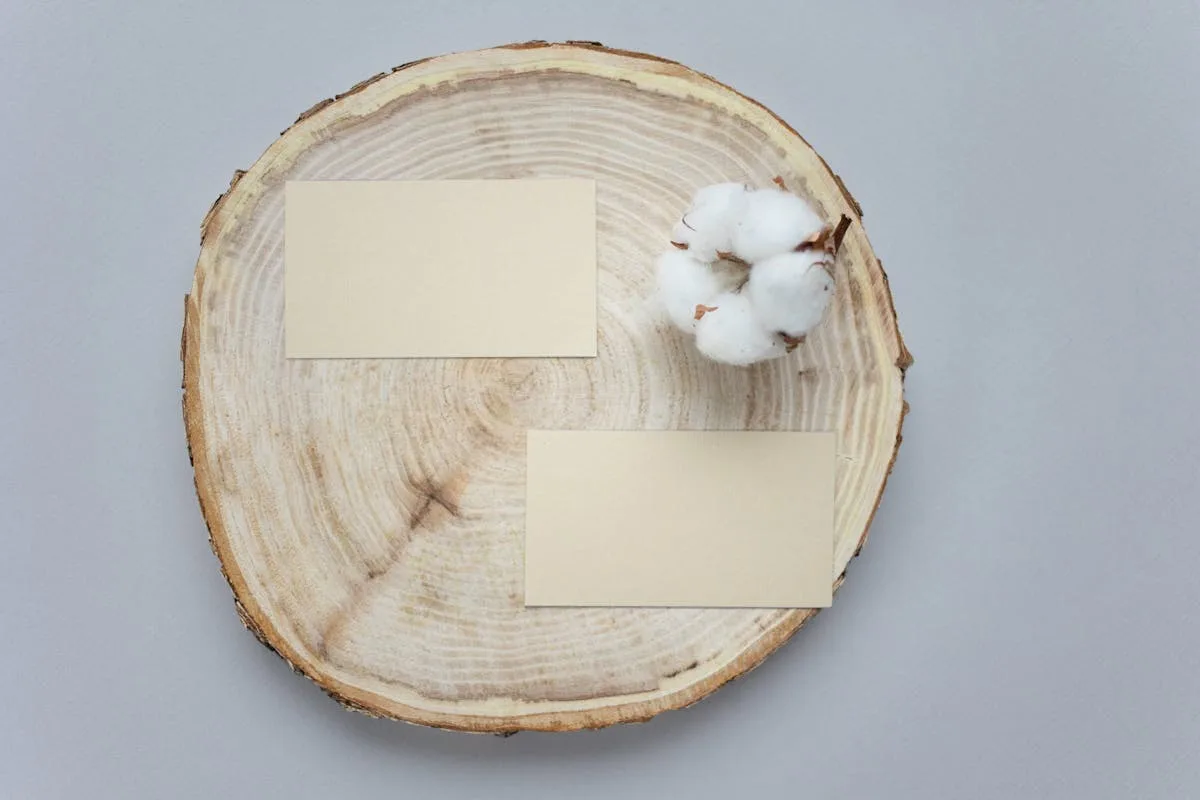 Soft cream branding cards on a wooden slice with cotton