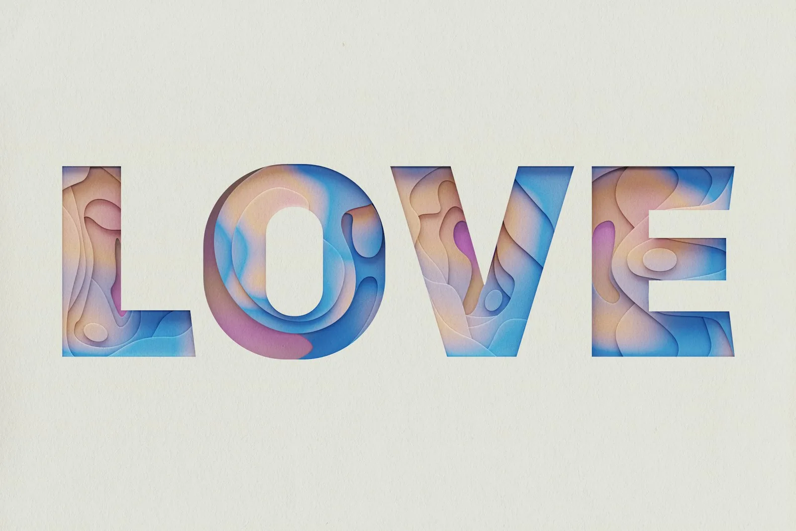 Colorful dimensional letters spelling love on a cream background