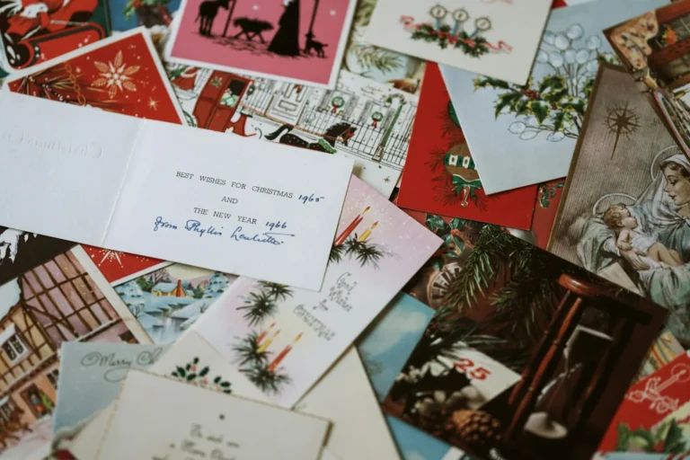 Christmas scrapbook flatlay with festive holiday cards and printed photos
