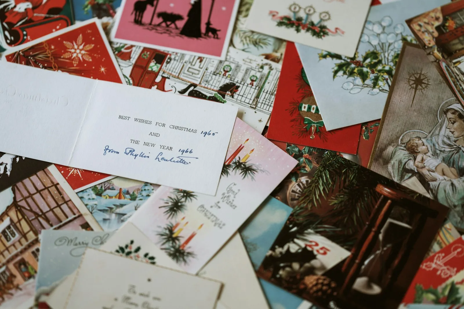 Christmas scrapbook flatlay with festive holiday cards and printed photos