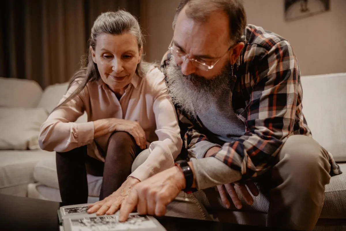 Family looking through a wedding photo album together years later