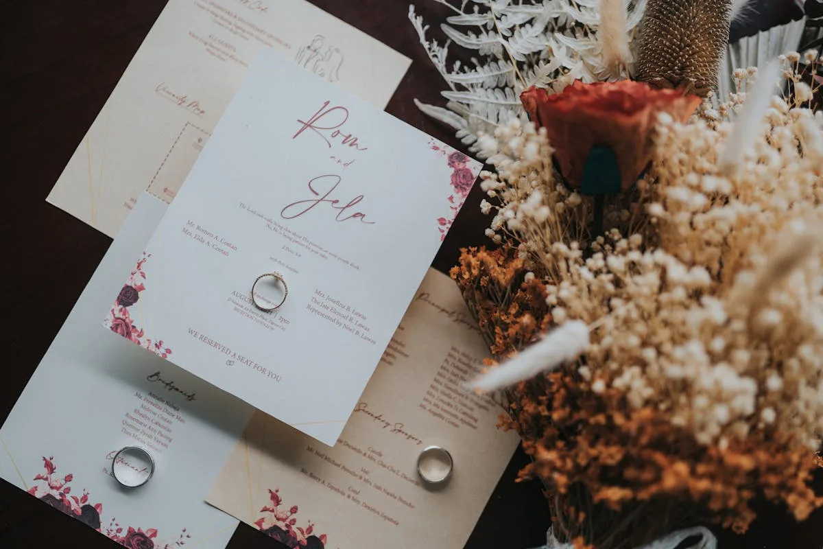 Wedding invitation cards and dried flowers saved as scrapbook keepsakes