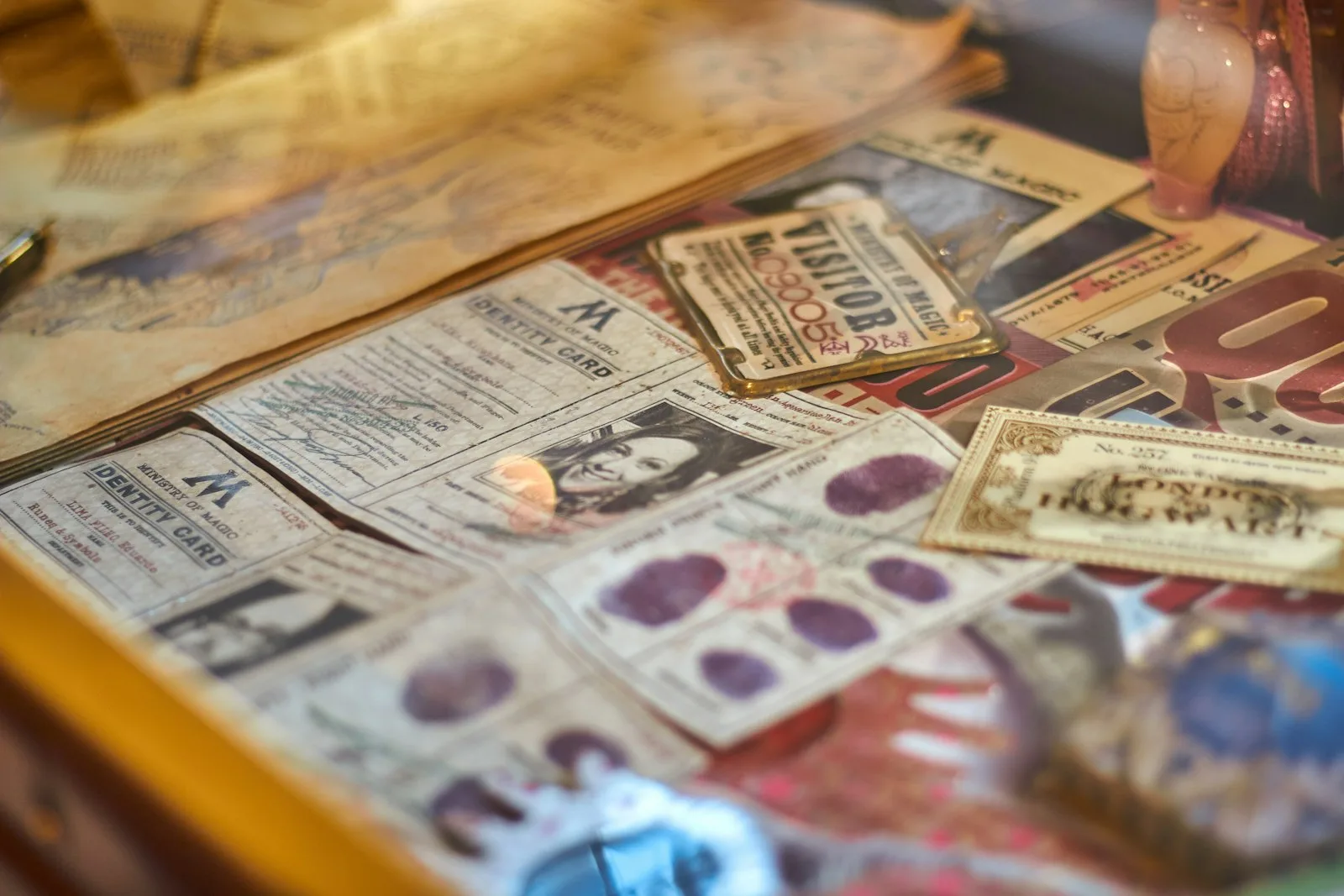 Vintage ephemera spread out on a table: old tickets, labels and printed cards with ornate lettering